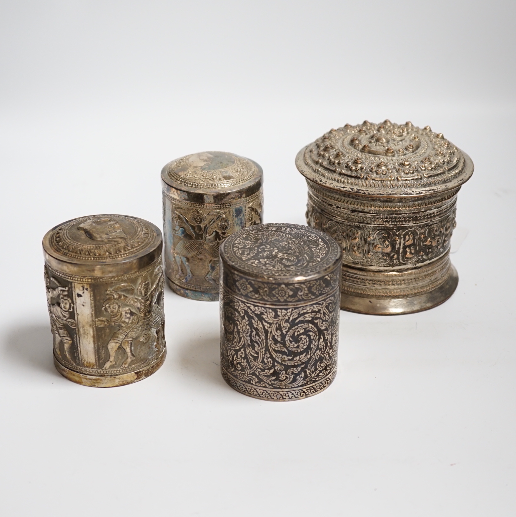Three Burmese white metal boxes, and a Thai silver and niello work box, tallest 11cm